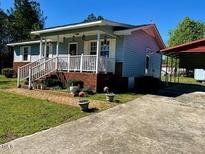 Charming single-story home with covered porch, landscaped yard and brick foundation at 543 Stockyard Rd, Staley, NC 27355