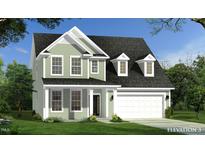 Charming two-story home featuring a lush lawn and attached two-car garage at 567 Winding Creek Dr, Lillington, NC 27546