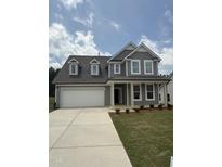 Charming two-story home with gray siding, dormer windows, and a covered front porch at 567 Winding Creek Dr, Lillington, NC 27546