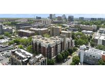 Stunning aerial view of building with red brick accents, surrounded by lush trees and city skyline in the background at 618 N Boylan Ave # 400, Raleigh, NC 27603