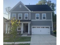 Charming gray two-story home featuring a two-car garage, stone accents, and well-manicured lawn at 633 Hardin Hill Ln, Knightdale, NC 27545