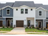 New construction townhomes with attached garages and lawn at 1047 Winding Spring Dr, Mebane, NC 27302