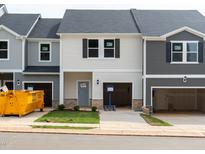New construction townhomes with attached garages and craftsman-style details at 1051 Winding Spring Dr, Mebane, NC 27302
