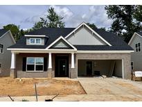 Charming single-story home featuring a brick facade, an attached two-car garage, and classic architectural detailing at 1085 Fairhaven Dr # 49, Mebane, NC 27302