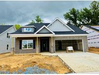 Charming new home featuring gray brick, a dormer window, and an attached two-car garage at 1085 Fairhaven Dr # 49, Mebane, NC 27302