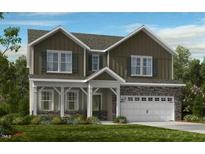 Charming two-story home featuring stone accents, a covered porch, and a two-car garage at 1125 Sun Springs Rd, Wake Forest, NC 27587