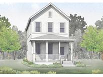 Charming two-story home with a welcoming front porch and well-maintained landscaping at 127 Mossy Falls Way, Wendell, NC 27591