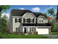 Charming two-story home featuring gray siding, black shutters, stone accents, and a two-car garage at 149 Whimbrel Ct, Lillington, NC 27546