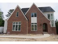 Charming red brick home with white trim and a well-manicured lawn, offering classic curb appeal at 2590 Silas Peak Ln, Apex, NC 27523