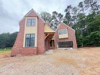 New brick home shows unique construction with open garage and stylish windows at 3324 Founding Place, Raleigh, NC 27612