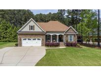 Charming stone and siding home with well-manicured lawn and attached two car garage at 3612 Griffice Mill Rd, Raleigh, NC 27610
