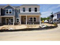 New two-story home showcasing architectural details and awaiting final landscaping at 3710 Rosebush Dr, Zebulon, NC 27597