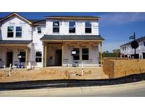 New construction home featuring Tyvek wrap, and visible framework under a clear blue sky at 3710 Rosebush Dr, Zebulon, NC 27597