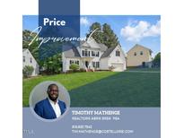 Charming two-story home with beautiful landscaping and a large front lawn at 4418 Gallatree Ln, Raleigh, NC 27616
