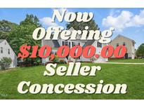 Traditional home featuring manicured lawn, white siding, black shutters, and an offering for a $10,000 seller concession at 4418 Gallatree Ln, Raleigh, NC 27616