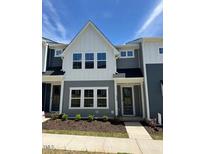 Charming two-story townhome featuring neutral-toned siding and a well-manicured lawn, perfect for comfortable living at 604 Hyperion Aly, Wake Forest, NC 27587