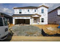 Exterior of new two-story home with Tyvek HomeWrap in the process of being built showing its framing and structure at 640 White Birch Ln, Angier, NC 27501