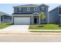 Charming two-story home with a two-car garage, manicured lawn, and inviting front entrance at 640 White Birch Ln, Angier, NC 27501