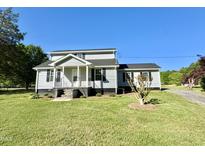 Charming two-story home with landscaped yard and covered front porch at 668 Surl Mount Tirzah Rd, Timberlake, NC 27583