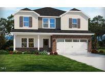 Charming two-story home with brick accents, attached two-car garage and manicured lawn at 741 Deschutes Dr, Garner, NC 27529