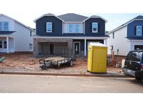 New two-story home features a brick-facade garage and modern, dark blue siding on the upper level at 741 Deschutes Dr, Garner, NC 27529