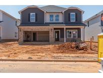 Two-story home with a two-car garage and brick and siding details at 741 Deschutes Dr, Garner, NC 27529