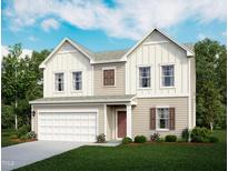 Charming two-story home featuring a two-car garage, beautifully landscaped yard and craftsman style architecture at 944 Bombardier Ln, Spring Hope, NC 27882