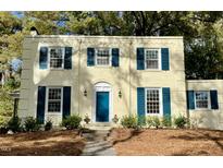 Charming two-story home with a blue front door and manicured landscaping at 112 Hilton Ave, Durham, NC 27707
