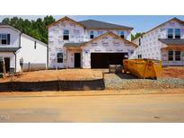 New home construction with Tyvek wrap, showcasing the early stages of the build at 1139 Winding Spring Dr, Mebane, NC 27302