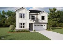 Charming two-story home with white siding, well-manicured lawn, and an attached two-car garage at 148 Sprenger St, Garner, NC 27529