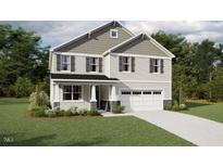 Charming two-story home featuring a two-car garage, neutral color palette, and manicured lawn at 172 Sprenger St, Garner, NC 27529