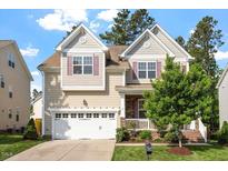 Inviting two-story home with a two-car garage and manicured lawn at 1910 Morehead Hill Ct, Durham, NC 27703