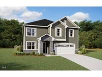 Charming two-story home featuring a well-manicured lawn and an attached two-car garage at 192 Sargents St, Garner, NC 27529
