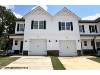 New construction townhome with white siding, black shutters, and two-car garage at 33 Calluna Dr, Clayton, NC 27520