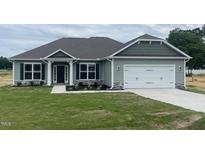 Charming one-story home featuring a two-car garage, well-manicured lawn and stone accents at 473 Sweet Potato Lane # 12, Nashville, NC 27856