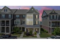 Charming townhome with landscaped front yard and covered porch, perfect for relaxing outdoors at 520 Austin View Blvd, Wake Forest, NC 27587