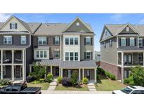 Charming townhome with well-kept lawn and inviting entrance, featuring traditional architectural details at 520 Austin View Blvd, Wake Forest, NC 27587