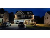 Charming two-story home with an attached garage and a well-manicured front yard in the evening at 528 Brycewood Dr, Burlington, NC 27215