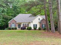 Charming ranch home with brick accents, black shutters, and a well-manicured lawn at 6673 Nc 96 W Hwy, Youngsville, NC 27596