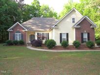 Charming one-story home with brick and vinyl siding and manicured front yard at 6673 Nc 96 W Hwy, Youngsville, NC 27596