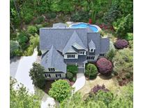 Stunning aerial view of the estate featuring a pool, lush landscaping, and a meticulously maintained home at 754 Olde Thompson Creek Ct Rd, Apex, NC 27523