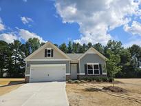 Charming single-story home with a two-car garage, landscaped yard, and a welcoming entrance at 79 Mildred Dr, Broadway, NC 27505