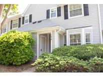 Charming townhome entrance with well-maintained landscaping and visible unit number at 104 Sir Richard Ln, Chapel Hill, NC 27517