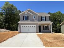 Charming two-story home with a two-car garage and a well-manicured lawn at 169 Pecan Valley Way, Four Oaks, NC 27524