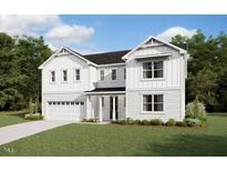 Charming two-story white home with a two car garage, landscaped lawn, and beautiful architectural details at 191 Yellow River Way, Garner, NC 27529