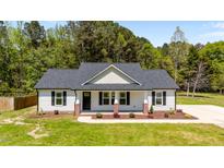 Charming single-story home featuring a landscaped front yard and classic architectural details at 1914 Jack Rd, Clayton, NC 27520