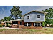 Charming two-story home with brick exterior, black shutters, and a well-manicured lawn at 202 November St, Garner, NC 27529