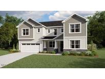 Charming two-story home featuring a two-car garage, white siding, and professionally landscaped yard at 207 Yellow River Way, Garner, NC 27529