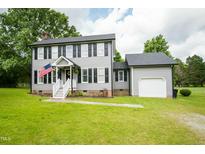 Charming two-story home with gray siding, black shutters, and a well-manicured lawn at 3004 Red Cir, Willow Springs, NC 27592