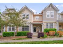 Inviting townhouse featuring well-maintained landscaping and a charming covered entrance at 4306 Brynwood Ave, Durham, NC 27713